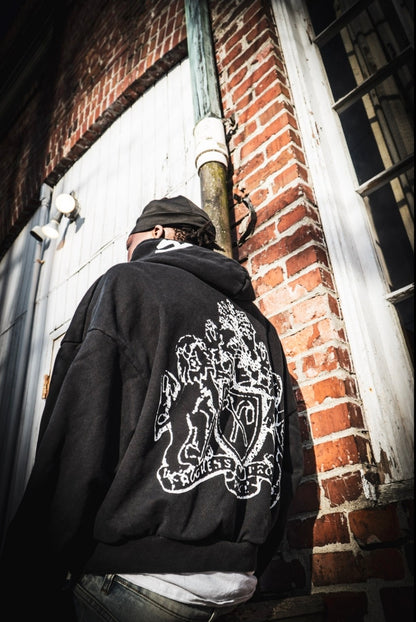 Shafra black hoodie brick wall closeup