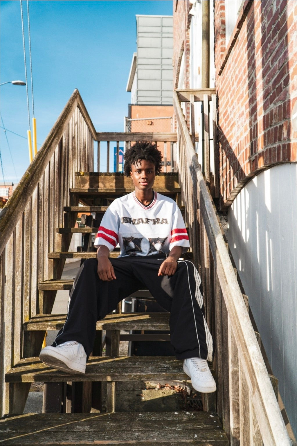 Shafra jersey seated portrait on stairs
